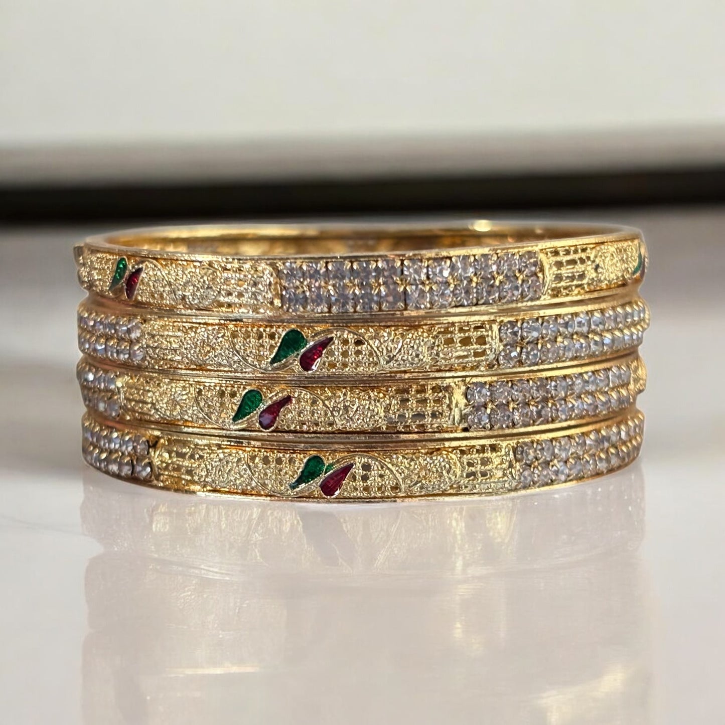 Elegant Gold Bangles with Diamond Accents and Meenakari Detailing – Set of 4